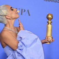 Lady Gaga poses with a Golden Globe