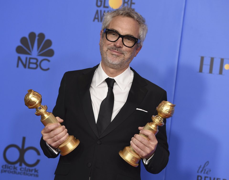 Alfonso Cuarón poses with two Golden Globes