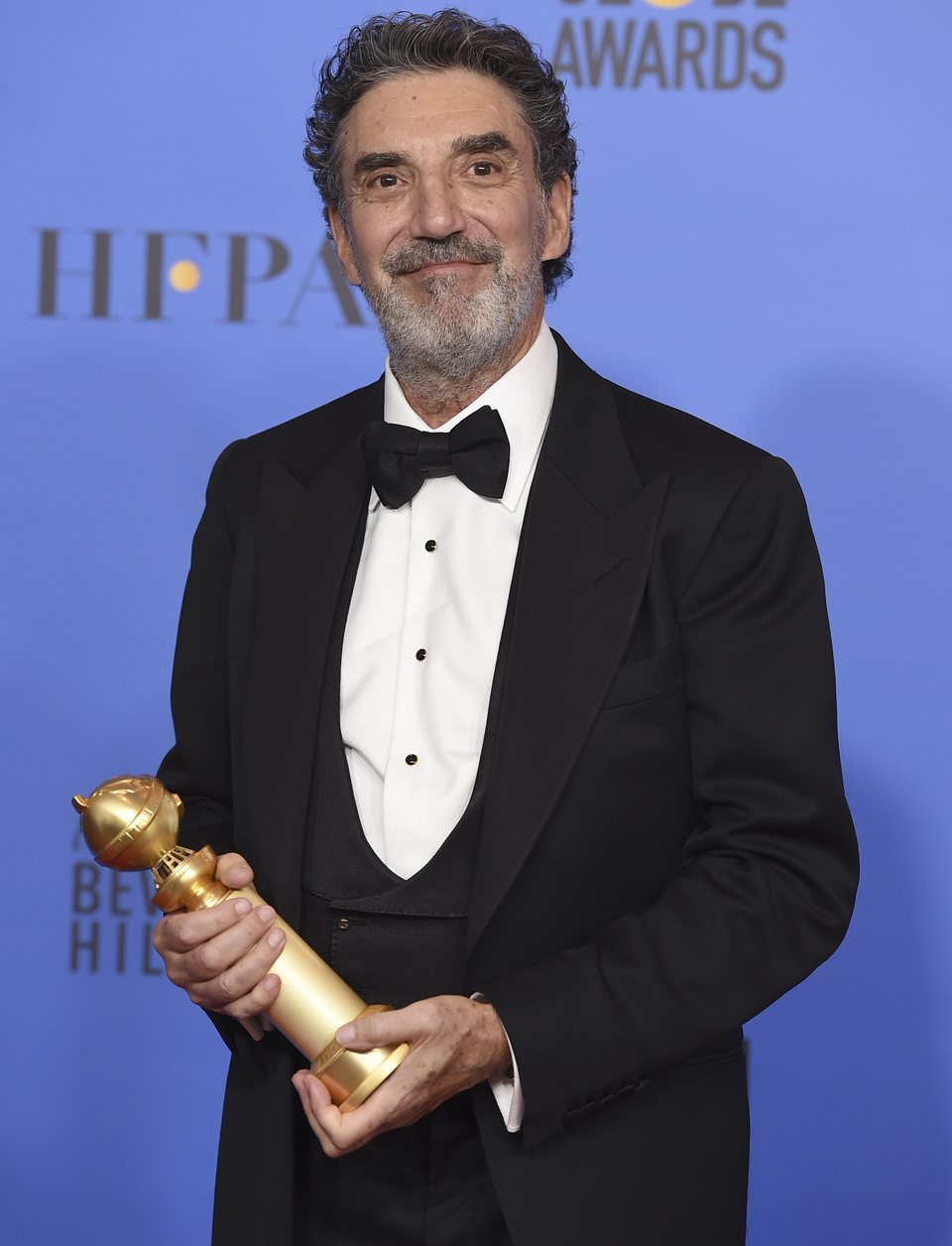 Chuck Lorre poses with the Golden Globe for Best Television Series, musical or comedy 