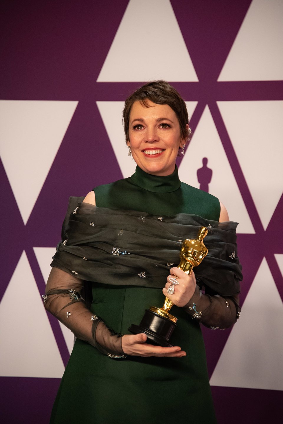 Olivia Colman poses with her Oscar