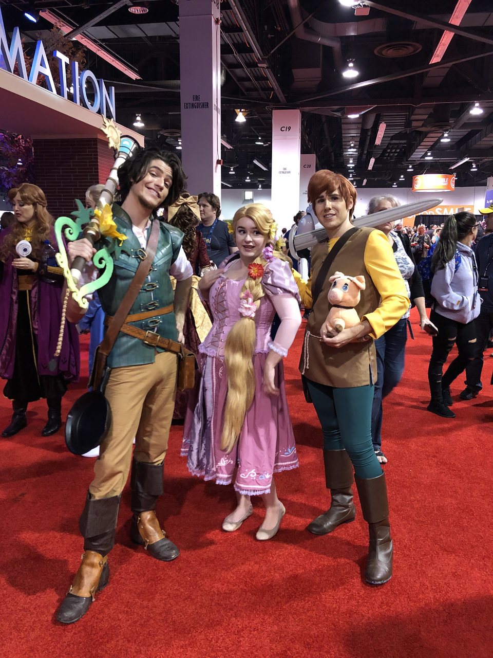 Fans dressed up as Flynn, Rapunzel and Taran, from 'Tangled' and 'The Black Cauldron'