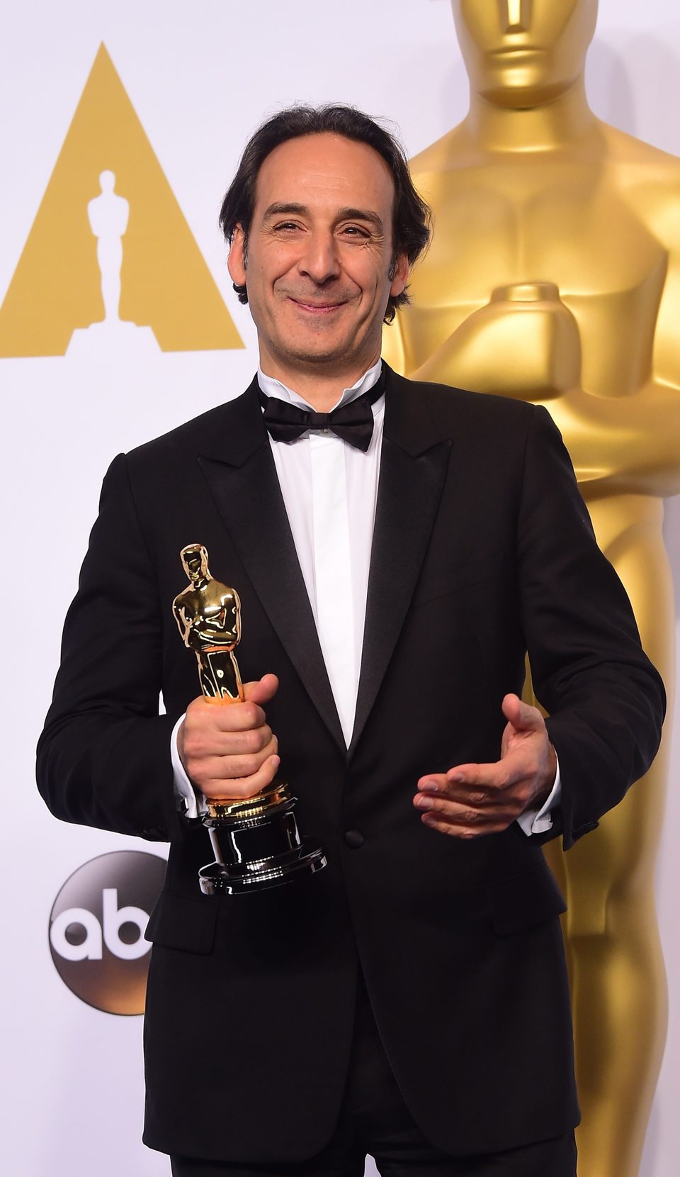 Alexandre Desplat poses with his first Oscar