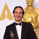 Alexandre Desplat poses with his first Oscar