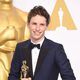 Eddie Redmayne poses with his first Oscar for the Best actor