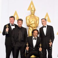 Alejandro González Iñárritu poses next to his three Oscars and Sean Penn