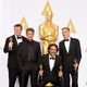 Alejandro González Iñárritu poses next to his three Oscars and Sean Penn