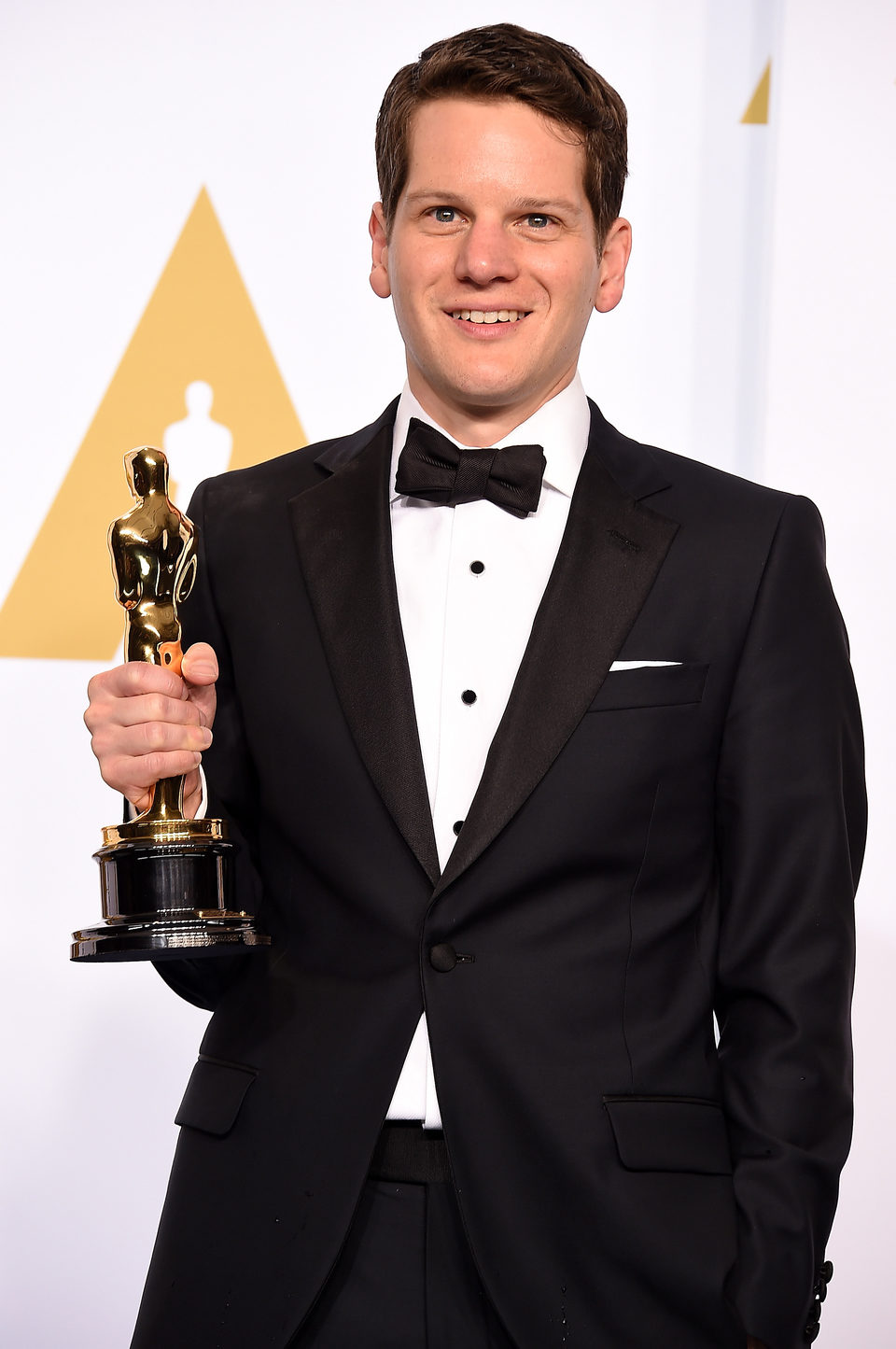 Graham Moore poses with his Oscar for the Best adapted screenplay