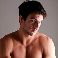 Shirtless Joaquín Ferreira looks shy to the camera