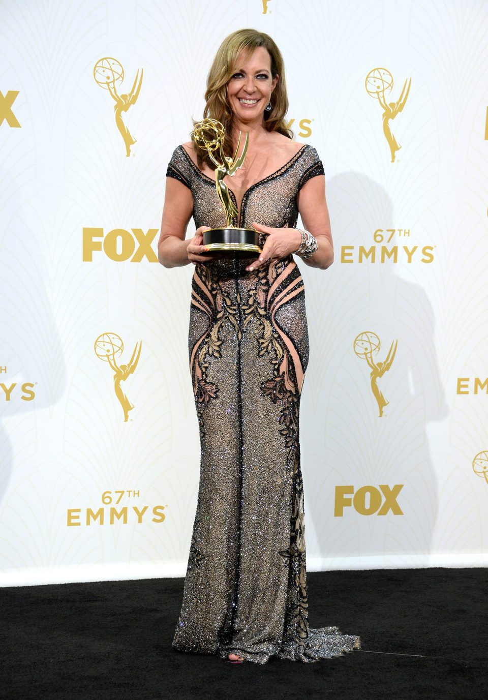 Allison Janney posing with her 2015 Emmy Award