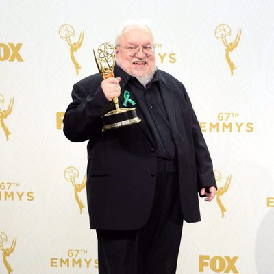 George R.R. Martin posing with his 2015 Emmy Award