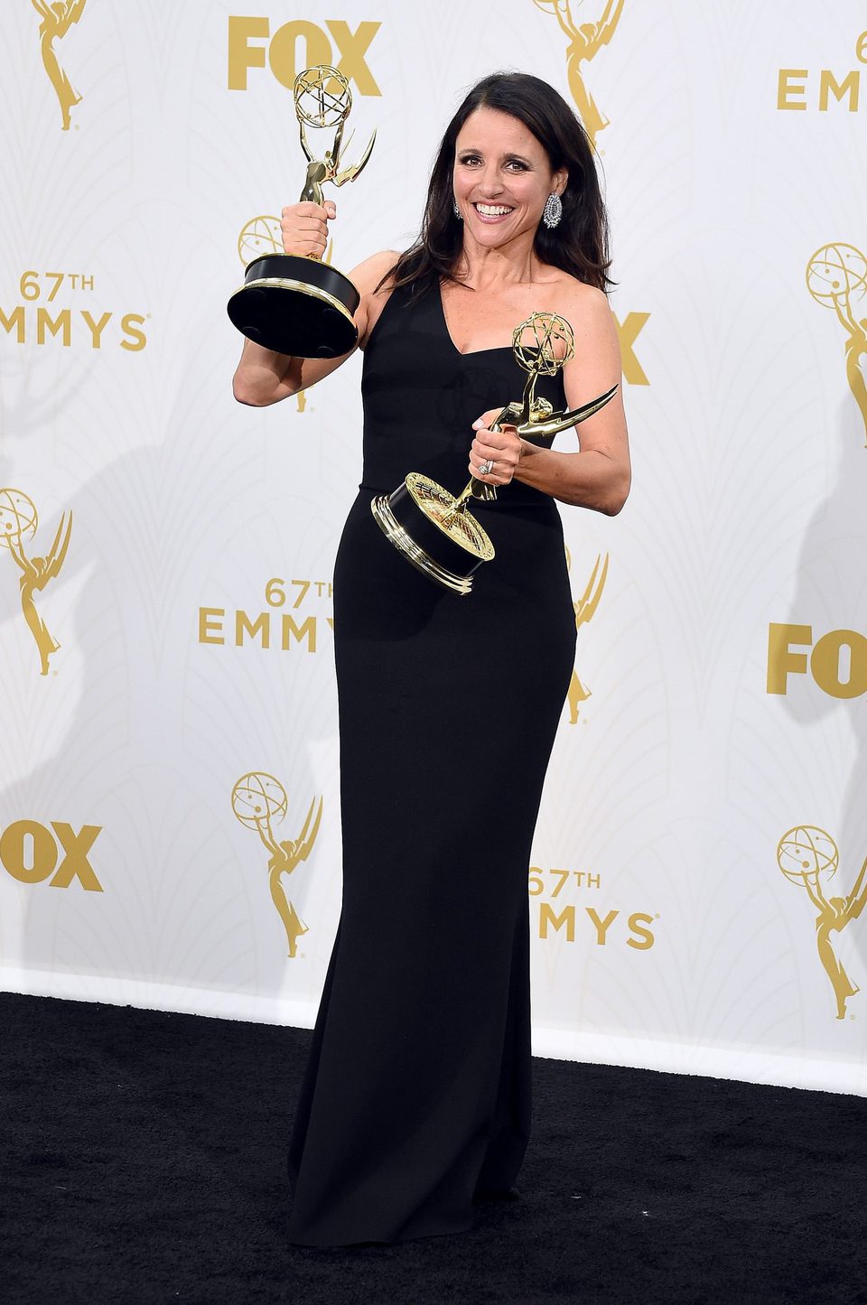 Julia Louis-Dreyfus posing with her two 2015 Emmy Awards