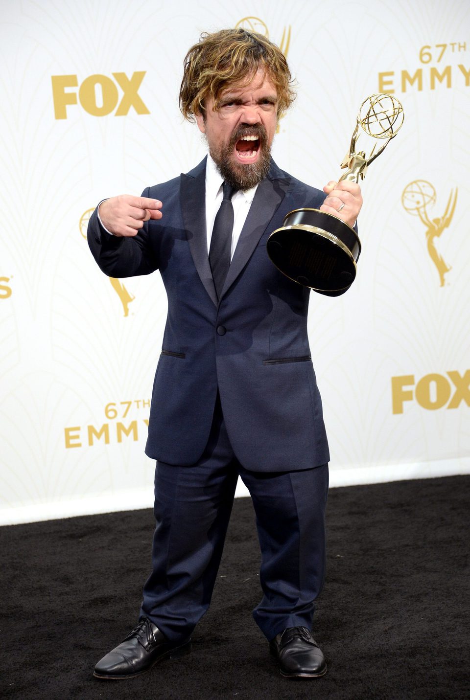 Peter Dinklage posing with his 2015 Emmy Award