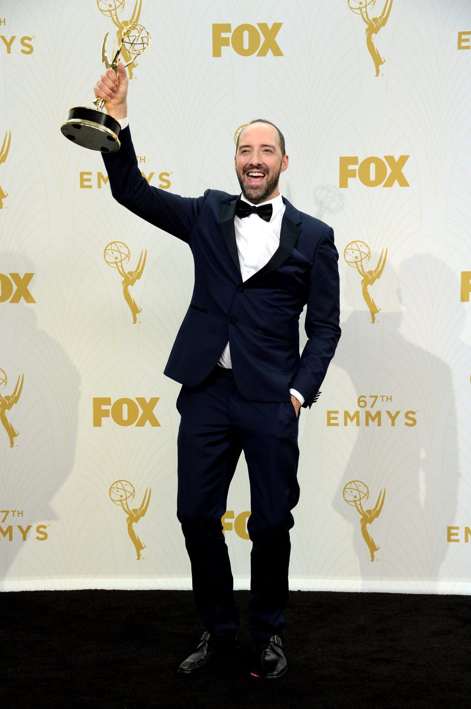 Tony Hale posing with his 2015 Emmy Award