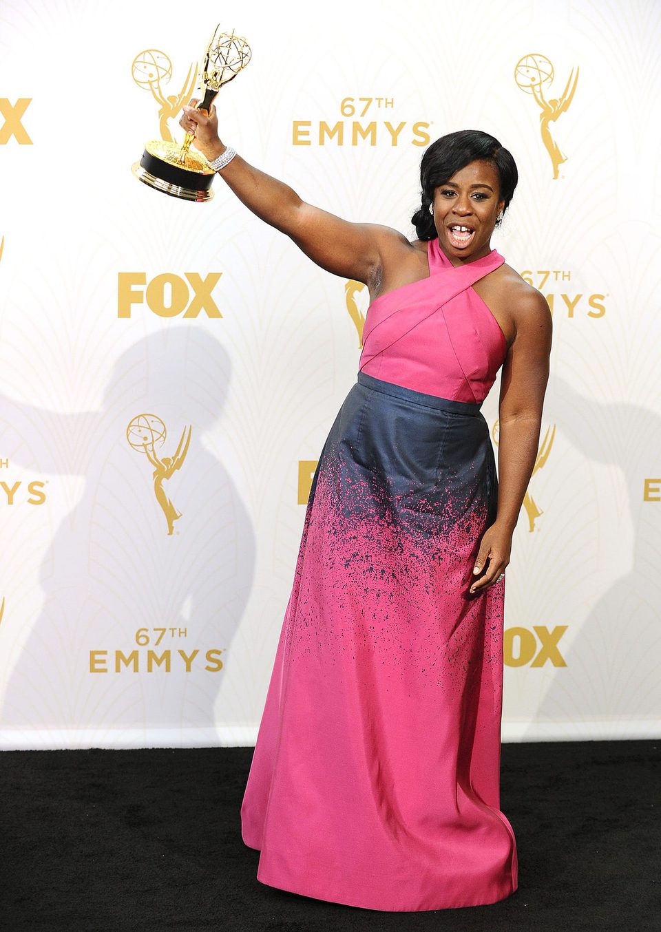 Uzo Aduba posing with her 2015 Emmy Award