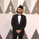 The Weeknd poses at the Oscars 2016 red carpet