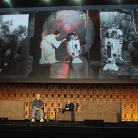 Warwick Davis and George Lucas in the Star Wars Celebration