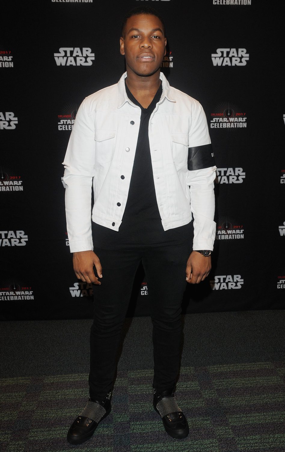 John Boyega goes to Star Wars Celebration, and poses before the panel of 'The Last Jedi'