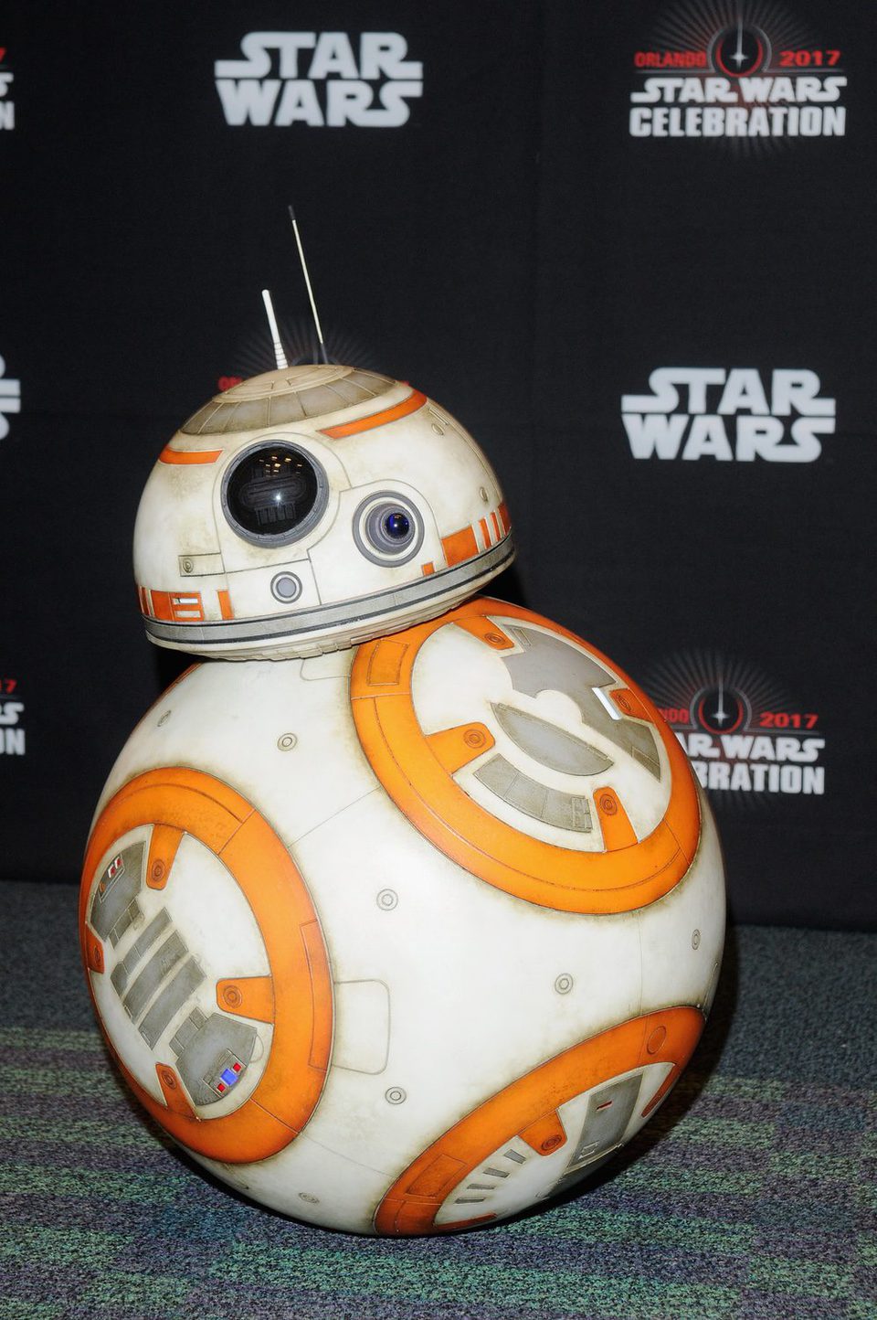 The robot BB-8 poses before the panel of 'The last Jedi' in the Star Wars Celebration