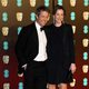 Hugh Grant and Anna Eberstein at the BAFTA Awards' 2018 red carpet