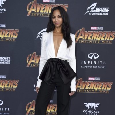 Zoe Saldana poses on the purple carpet at the world premiere of 'Aevengers: Infinity War'