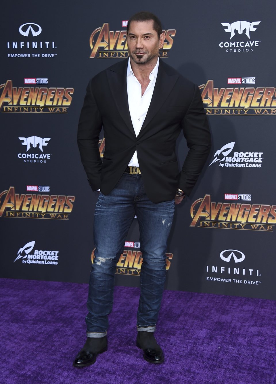 Dave Bautista poses on the purple carpet for the world premiere of 'Avengers: Infinity War'