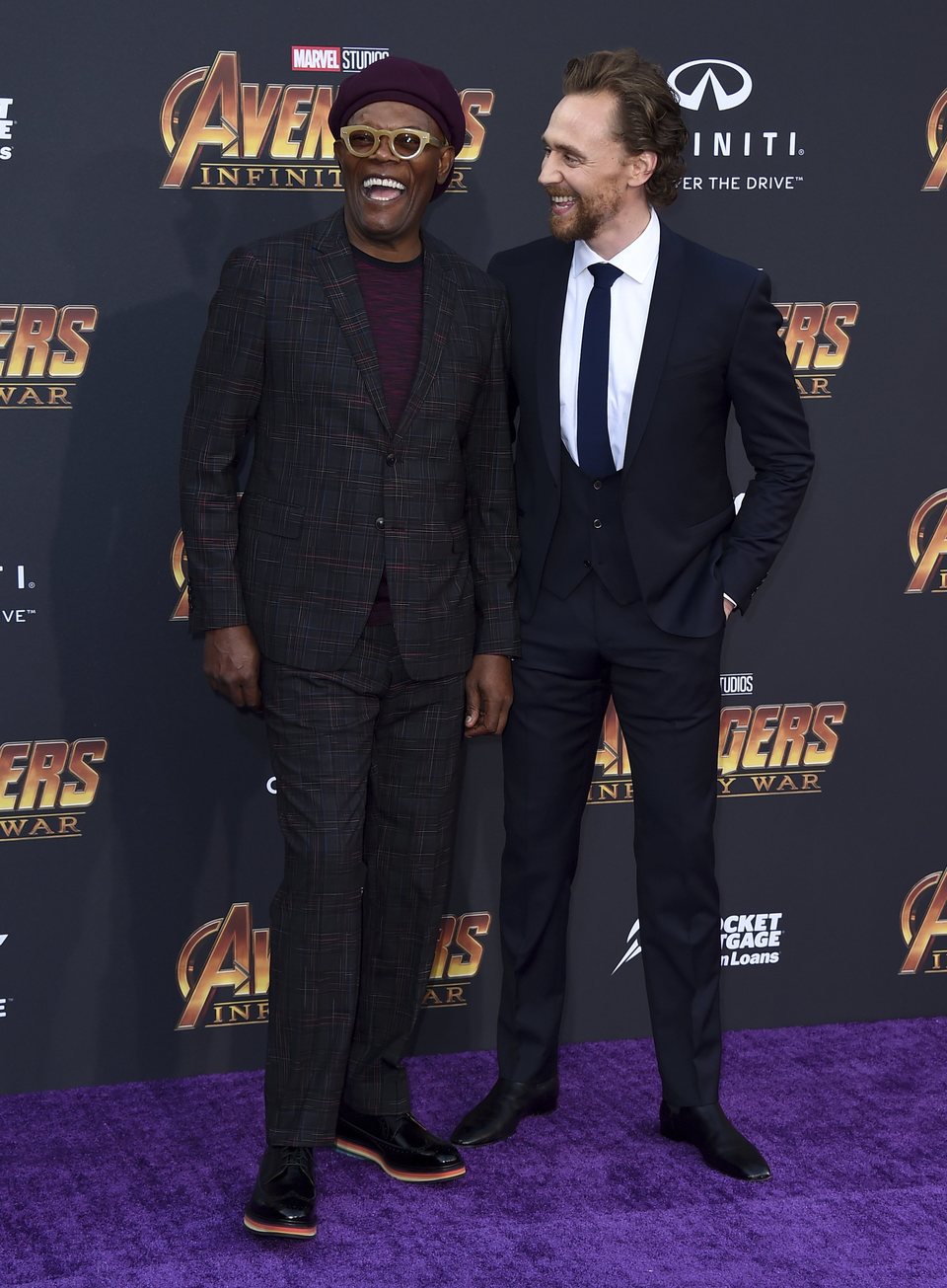 Samuel L. Jackson and Tom Hiddleston pose together on the purple carpet at the world premiere of 'Avengers: Infinity War'