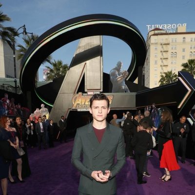 Tom Holland poses on the purple carpet at the world premiere of 'Avengers: Infinity War'