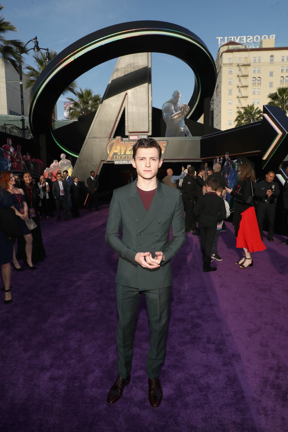 Tom Holland poses on the purple carpet at the world premiere of 'Avengers: Infinity War'